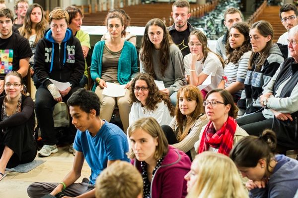 Group of teenagers sitting on the ground in church